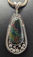 Load image into Gallery viewer, A sterling silver pendant featuring a teardrop-shaped bloodstone with decorative wire and sterling 'tear drops', mounted on a silver back plate.
